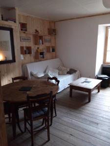 a living room with a table and a couch at Au 17 in Murat +9 photos