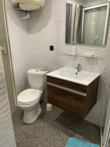 a bathroom with a toilet and a sink at Studio près de la mer in Port-Vendres