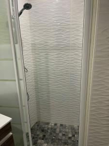 a shower with a glass door in a bathroom at Studio près de la mer in Port-Vendres