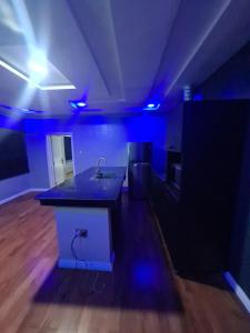a room with a kitchen with a sink and blue lights at Wine House, Maitama, Abuja in Abuja +191 photos