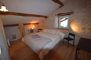 a bedroom with a large bed and a window at Roc du Lapin in Sainte-Colombe-de-Villeneuve