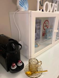 a cup of tea on a table next to a microwave at Loft Edificio Maura Primera Playa in Santander