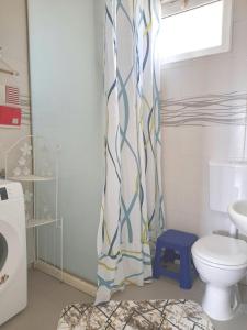 a bathroom with a toilet and a shower curtain at Apartman SB in Ulcinj