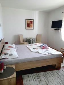 a bedroom with a large bed with white sheets at Apartman SB in Ulcinj