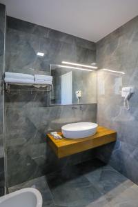 a bathroom with a sink and a mirror at Villa Kristiano 21 in Sarandë