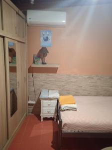 a small bedroom with a bed and a table at Το Μικρό Σπίτι στη Φάρμα! in Acharnes