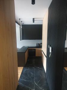 an open door to a kitchen with a sink at Apartament Szyndzielnia in Bielsko-Biala