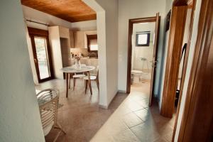 a kitchen and dining room with a table and chairs at Enalio Beach House in Nea Kallikrateia +20 photos