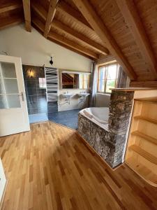 a large bathroom with a stone tub and a sink at Charmante Ferienwohnung für Pärchen in Kašperské Hory
