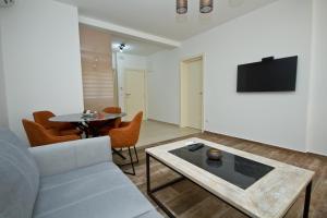 a living room with a couch and a table at IgMAN apartments Tivat in Tivat