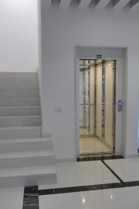 a staircase with a glass door in a building at Central Modern Apartment Bari in Bari