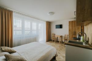 a hotel room with a bed and a sink at FAMILKA in Karwia