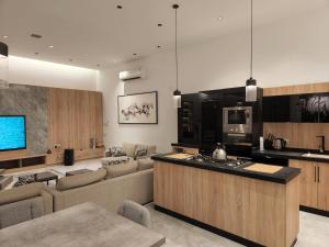 a kitchen and living room with a couch and a counter at شاليه فاخر جداً جداً وخاص in Riyadh