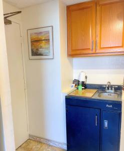 a kitchen with a blue counter and a sink at Hawaiian Monarch 2508 condo in Honolulu