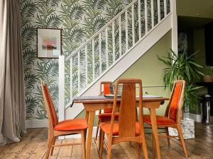a dining room with a table and four chairs at The Victorian Post House - Central Frome in Frome
