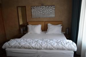 Postel nebo postele na pokoji v ubytování Garni Hotel Chicha - Winery ŠKRBIĆ