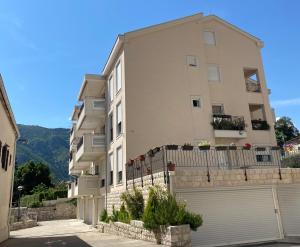 a large apartment building with a fence in front of it at Villa K LUX in Kotor