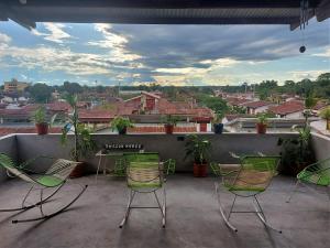 a group of chairs and a table on a balcony at Amazon House Hostel in Iquitos