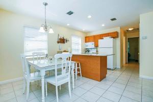 a kitchen and dining room with a table and chairs at Starfish East in Captiva