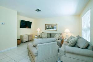 a living room with a couch and two couches at Starfish East in Captiva