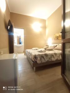 a bedroom with a bed and a bathroom with a tub at Villa Alfea CAMERE in Porto Cesareo