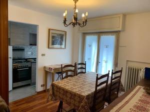 a kitchen and dining room with a table and chairs at Sunny two room apartment in Campo Carlo Magno in Madonna di Campiglio