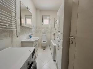 a white bathroom with a toilet and a sink at Villa K LUX in Kotor +21 photos