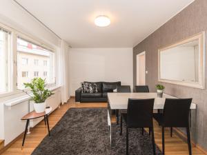 a living room with a table and a couch at Santa's Apartment in Rovaniemi