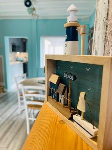 a small wooden box with a lighthouse in a room at The Rambler's Rest Cottage, Parkgate, Wirral in Parkgate