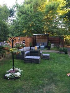 a backyard with a couch and flowers in the grass at Queens Guesthouse Manchester in Manchester