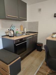 a small kitchen with a sink and a stove at Dream Home Studio Apartments in Tuzla +16 photos