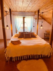 a bedroom with a large bed with a large window at Wellness Holiday House Lagev in Moravske Toplice