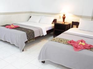 Mangga Bali Inn 객실 침대