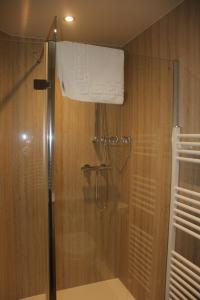 a shower with a glass door in a bathroom at The Red Lion in Lowick Green