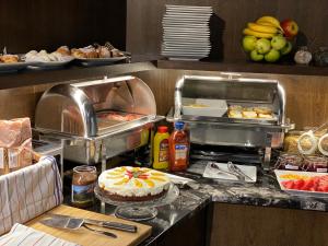 a buffet with a cake and other food on a counter at MOODs boutique hotel in Prague