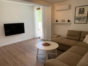 a living room with a couch and a table at Apartment Centar in Buljarica