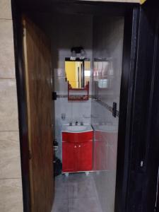 a bathroom with a red cabinet and a sink at MALARGÜE STYLE EXMAT CÉNTRICO,UBICADISIMO in Malargüe +9 photos