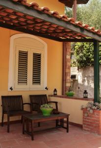 a patio with two chairs and a table on a patio at Villa Artemis in Graniti