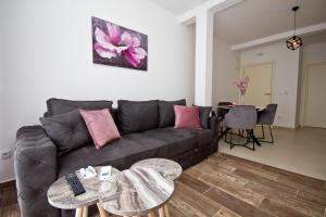 a living room with a couch and a table at IgMAN apartments Tivat in Tivat