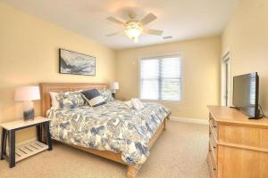 ein Schlafzimmer mit einem Bett und einem Flachbildfernseher in der Unterkunft Rock N Reel in Oak Island + 31 Fotos