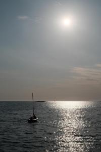 a small boat in the middle of the ocean at House Mateja Unije in Unije