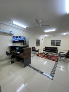 a living room with a desk and a tv at AL KALDi in Salalah