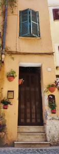 a building with a door and stairs in front at Affitto turistico - La Terrazzina in Monterotondo