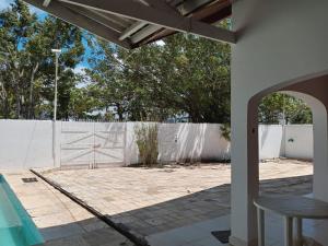 a backyard with a fence and a pool at Pousada Pérola do Guarujá Ltda- Me in Guarujá