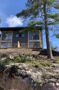 a house on top of a hill with a tree at Brand new mountain cabin in Branäs