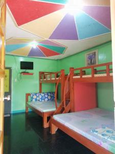 a room with two bunk beds and a ceiling at Glenmark's Homestay 2 in Mabubua