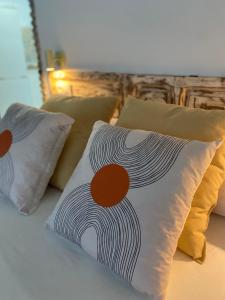 a bed with four pillows on top of it at CasaElbarranko in Arcos de la Frontera