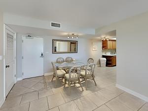 ein Esszimmer mit einem Tisch und Stühlen sowie eine Küche in der Unterkunft Regency Towers 302 West in Pensacola Beach