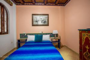 Tempat tidur dalam kamar di Hotel Chams