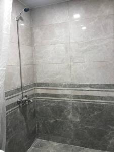 a bathroom with a shower with a glass door at Koms Guest House in Gyumri